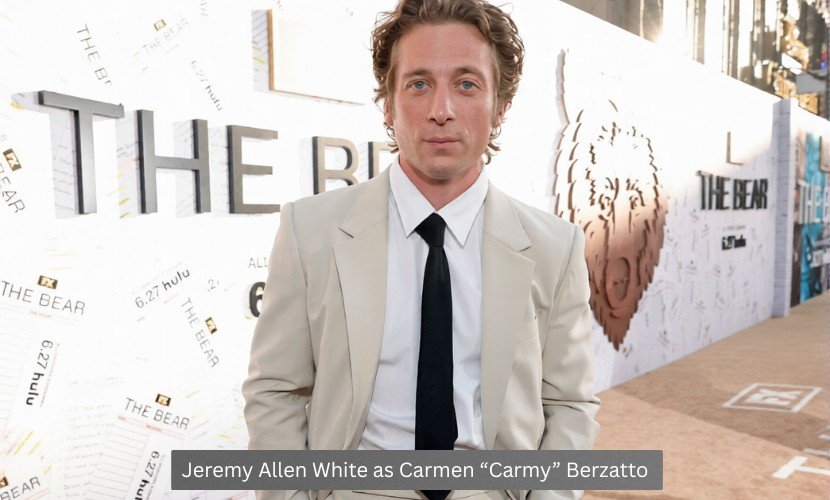 Jeremy Allen White posing at The Bear premiere event in a beige suit as Carmen “Carmy” Berzatto.